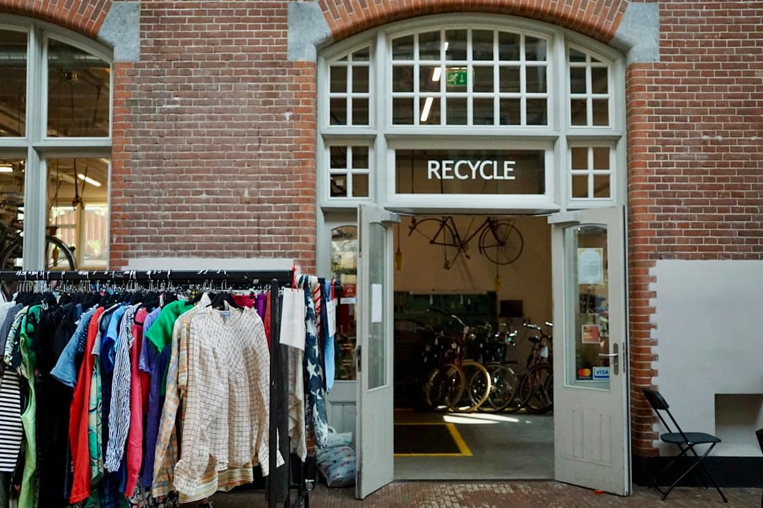 A recovery centre with reclaimed clothing and bicycles ready for reuse