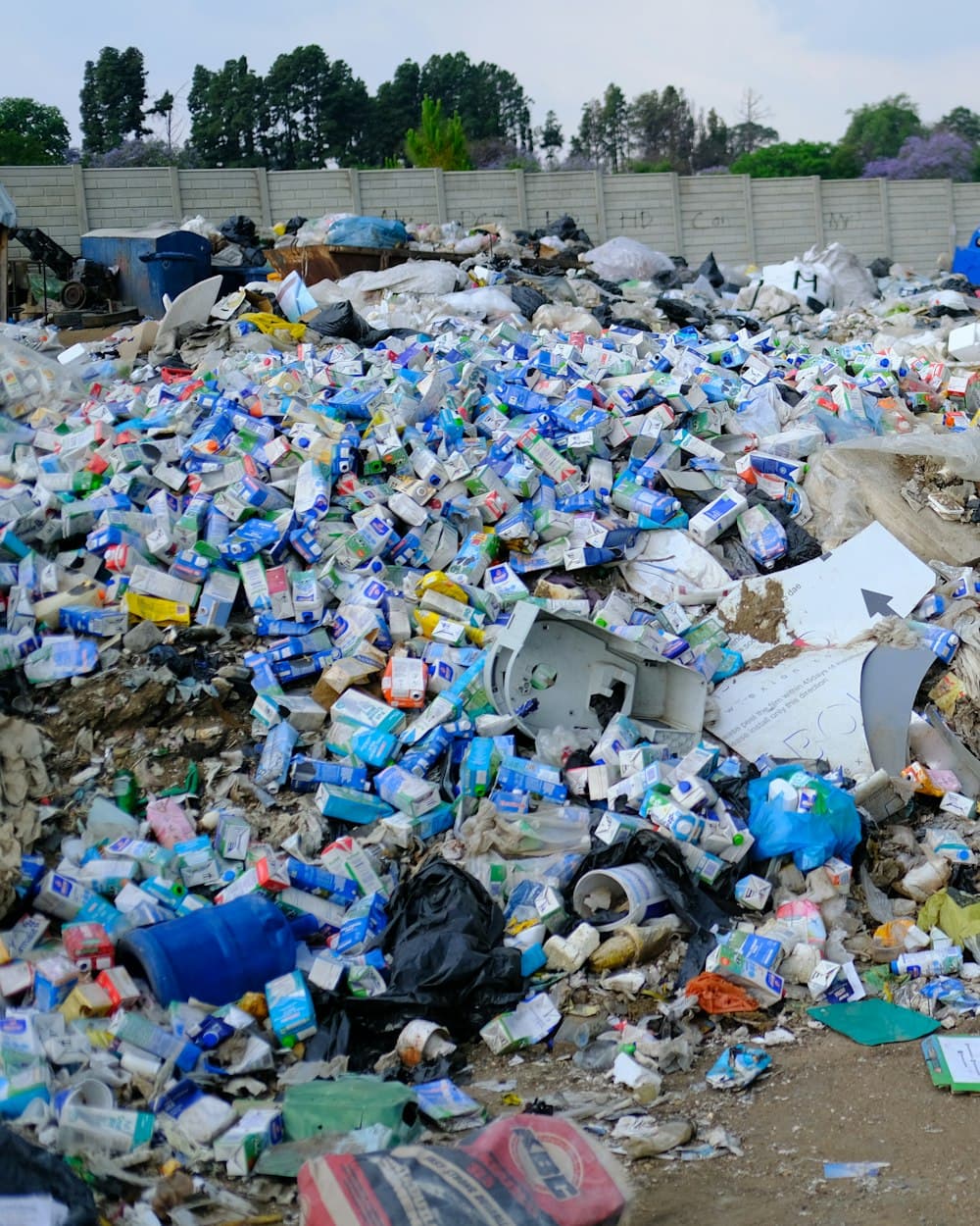 A vast landfill of discarded material stretching to the horizon